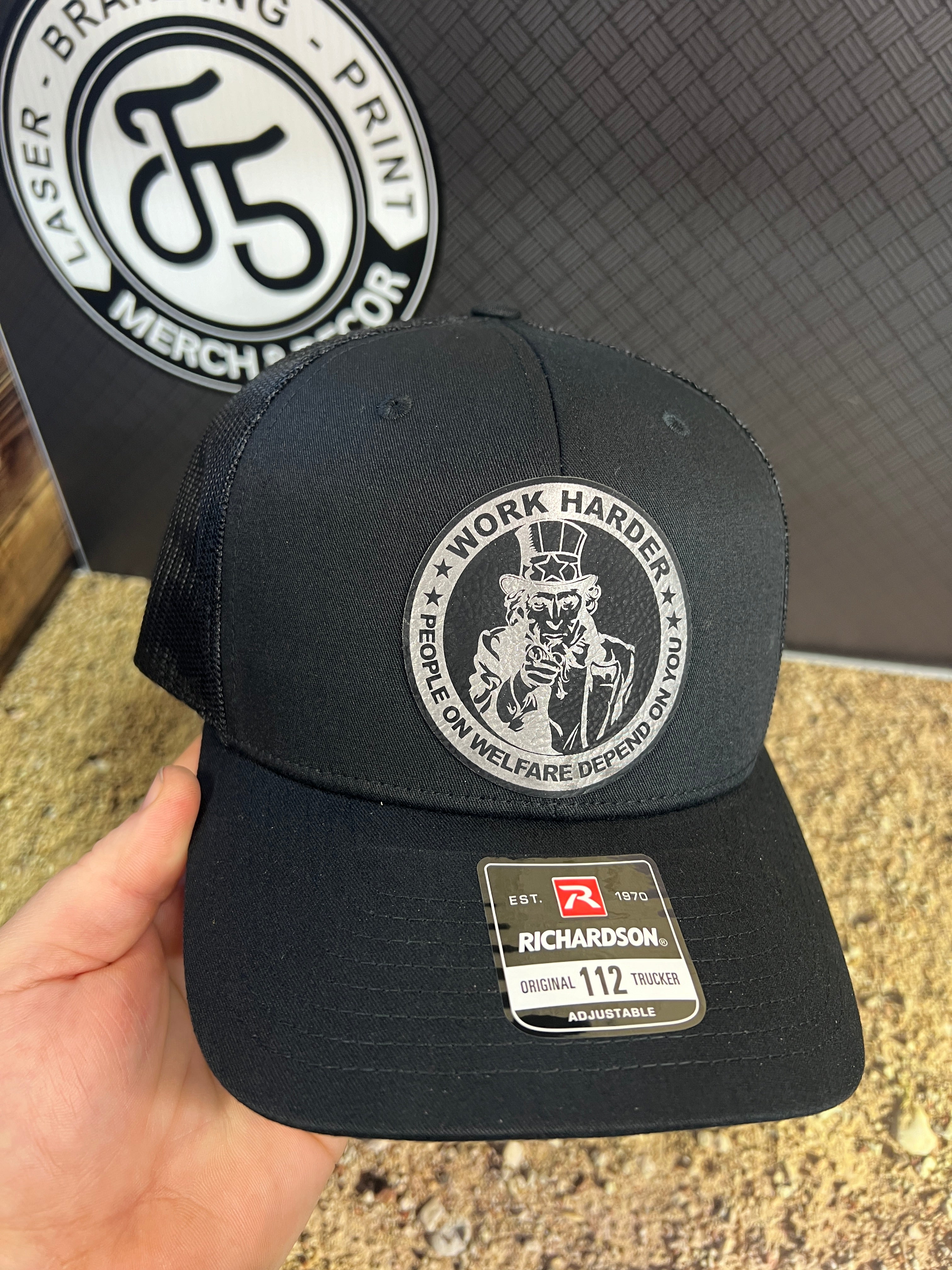 Work Harder Hat Design with a Premium Leatherette Patch on a Richardson 112 Trucker Hat for Conservative Americans.