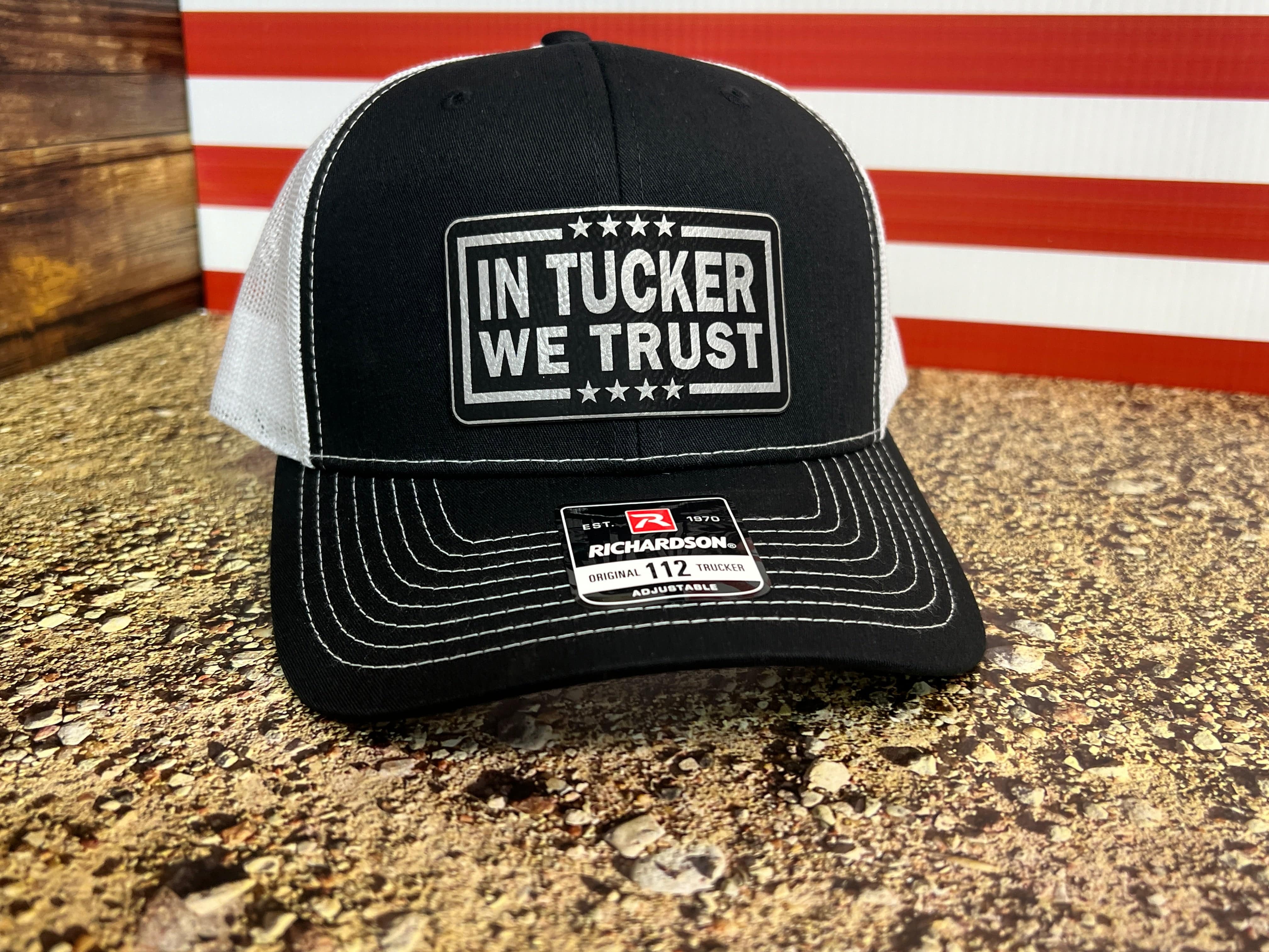 In Tucker We Trust Hat with Laser Engraved Premium Leatherette Patch on a Richardson 112 Trucker Hat.