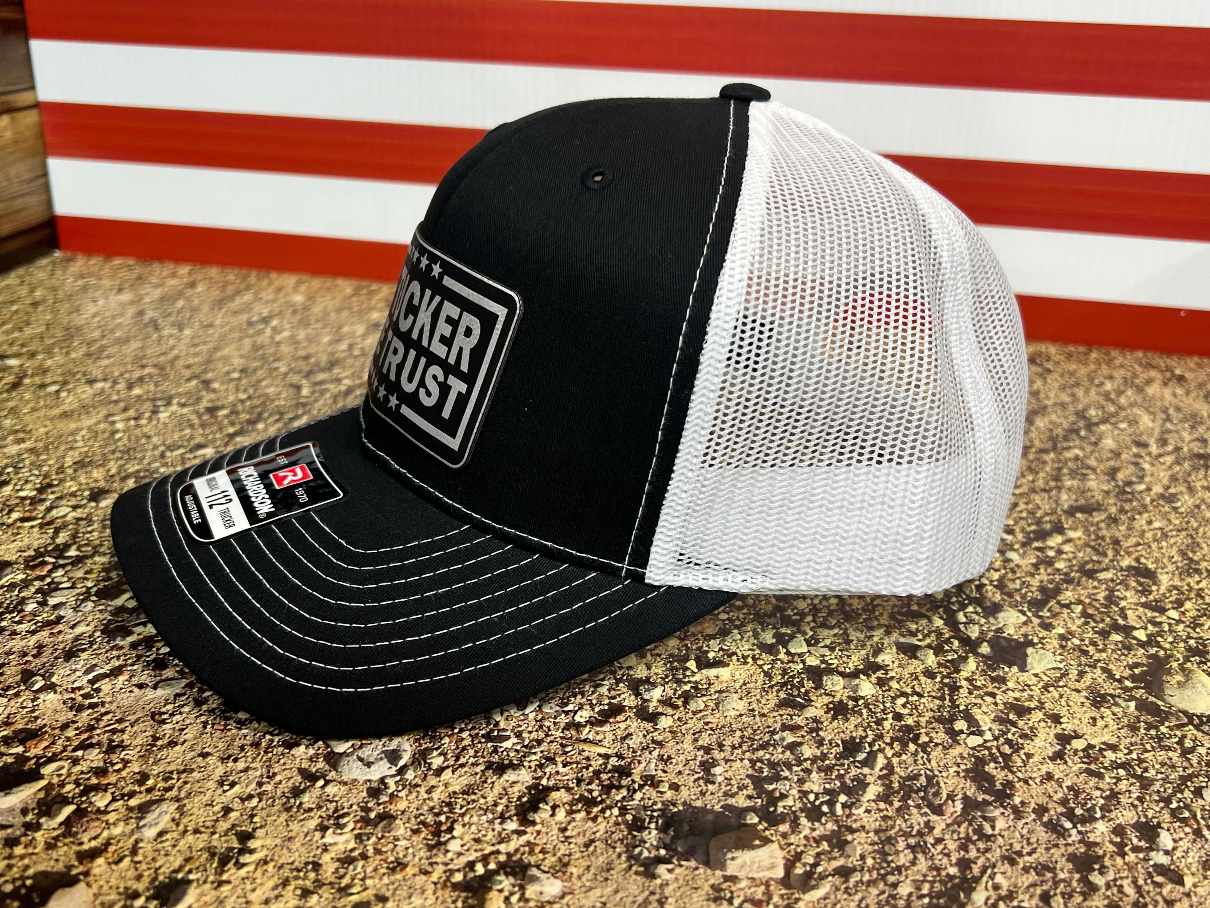 In Tucker We Trust Hat with Laser Engraved Premium Leatherette Patch on a Richardson 112 Trucker Hat.